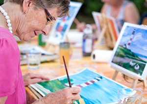 Image shows a lady painting