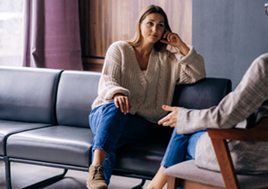 Image shows a lady talking to someone