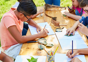 Image shows young people with art supplies